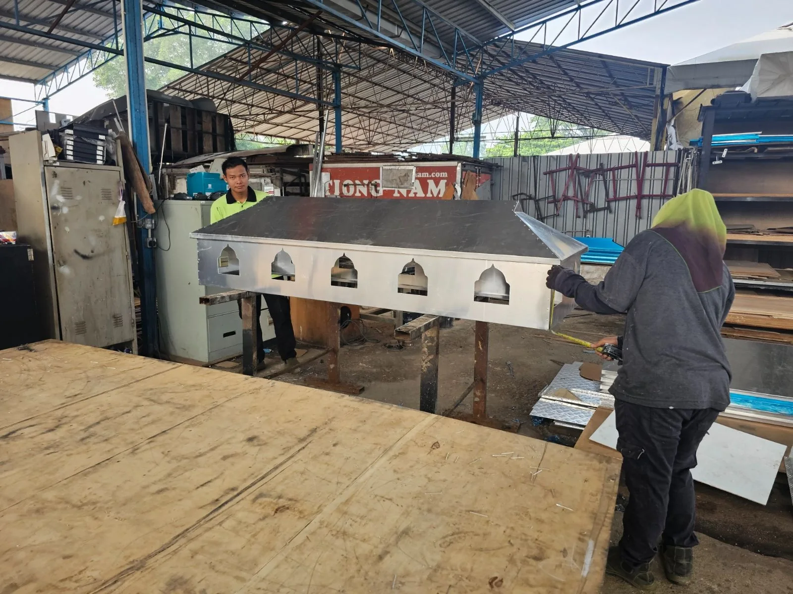 Workshop team assembling a custom metal structure